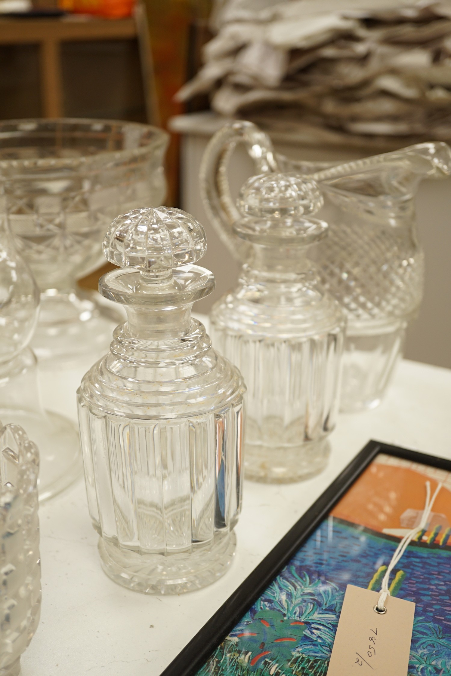 An early 20th century oval cut glass bowl on gilt metal stand, a pair of slice cut decanters and stoppers, a blown glass smoke bell two bowls and four other items of glassware, tallest 26 cm